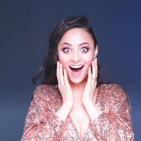 Beautiful young woman in evening dress on black backgroundの写真素材