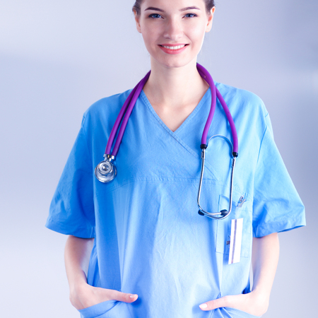 Portrait of young woman doctor standing in hospitalの写真素材