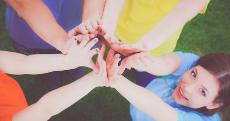 People joining their hands on green grassの写真素材
