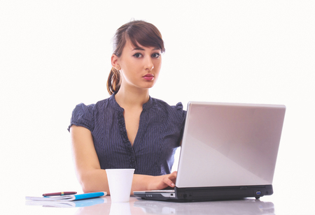Beautiful young woman on the workplace using a laptopの写真素材
