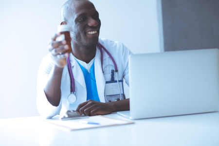 Close-up of male doctor giving jar of pills to patient. Doctor.の写真素材