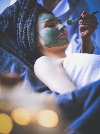 Beautiful woman having mask , lying on spa . Woman. Spa salonの写真素材