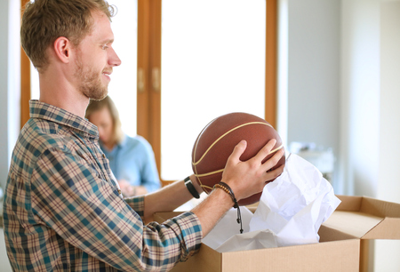 Couple unpacking cardboard boxes in their new homeの写真素材