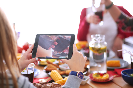 Top view of group of people having dinner together while sitting at wooden table. Food on the table. People eat fast foodの写真素材