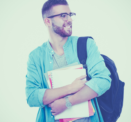 A male student with a school bag holding books isolated on white backgroundの写真素材