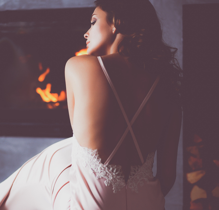 Sexy girl in front of the fireplaceの写真素材