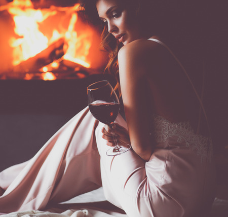 Sexy girl in front of the fireplaceの写真素材