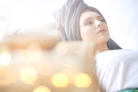 Young woman lying on a massage table,relaxing. Woman. Spa salonの写真素材
