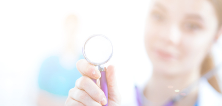 Female doctor with a stethoscope listening in hospitalの写真素材