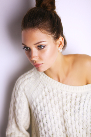 Portrait of a cute woman in sweater at homeの写真素材