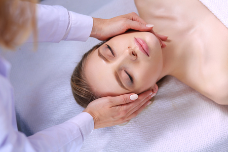 Young woman lying on a massage table,relaxing with eyes closed. Woman. Spa salonの写真素材