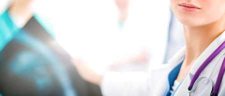 Attractive female doctor in front of medical groupの写真素材