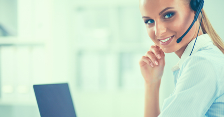 Close-up portrait of a customer service agent sitting at officeの写真素材