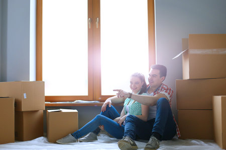 Couple moving in house sitting on the floor. Coupleの写真素材