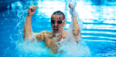 Male swimmer at the swimming pool. Underwater photoの写真素材