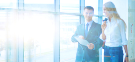 Businesspeople walking in the corridor of an business centerの写真素材