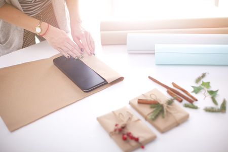 Hands of woman decorating christmas gift box. Hands of womanの写真素材