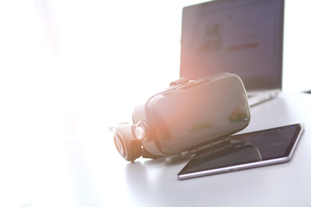 Virtual reality goggles on desk with laptop. business. 3d technology