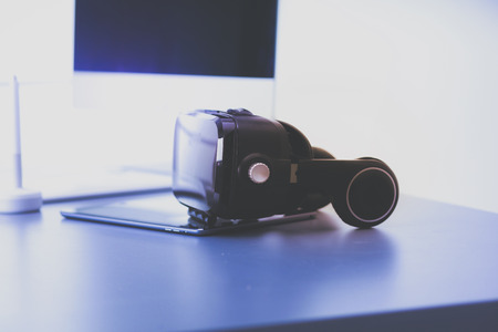 Virtual reality goggles on desk with laptop. business. 3d technologyの写真素材