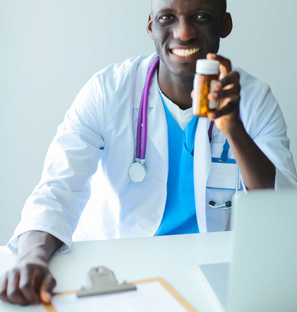 Close-up male doctor giving jar of pills to patient.の写真素材