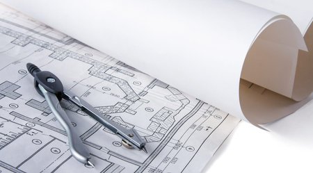 Architectural plans, compass and ruler on the desk