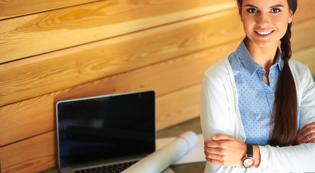 Young female standing near deskの写真素材