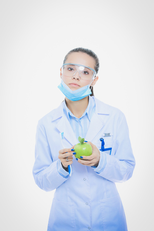 Dentist medical doctor woman hold green fresh apple in hand and tooth brush. Dentist doctors. Woman doctorsの写真素材