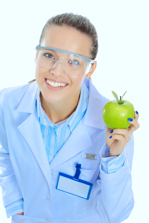 Dentist medical doctor woman hold green fresh apple in hand and tooth brush. Dentist doctors. Woman doctorsの写真素材