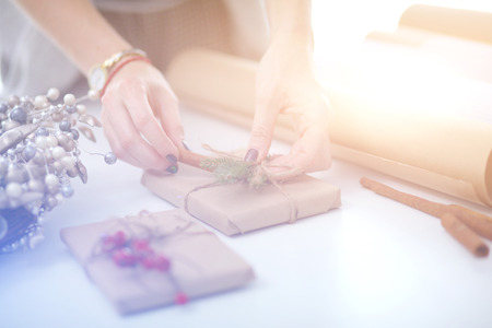 Hands of woman decorating christmas gift box. Hands of womanの写真素材