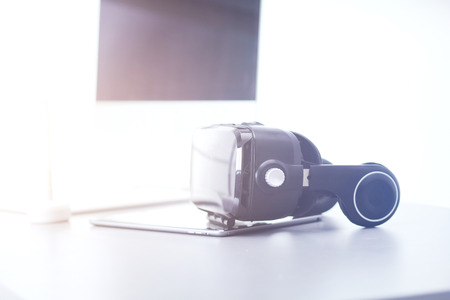 Virtual reality goggles on desk with laptop. business. 3d technologyの写真素材