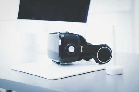 Virtual reality goggles on desk with laptop. business. 3d technologyの写真素材