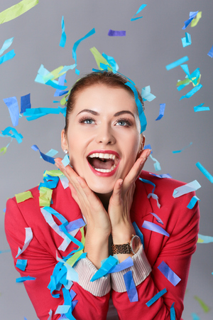 Beautiful happy woman at celebration party with confetti .Birthday or New Year eve celebrating conceptの写真素材