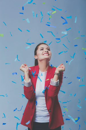 Beautiful happy woman at celebration party with confetti .Birthday or New Year eve celebrating conceptの写真素材