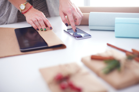Hands of woman decorating christmas gift box. Hands of womanの写真素材