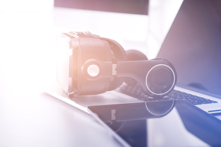 Virtual reality goggles on desk with laptop. business. 3d technologyの写真素材