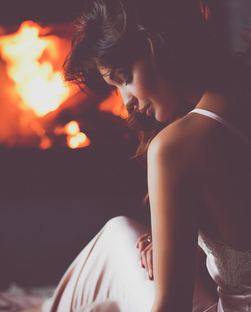 Sexy girl in front of the fireplaceの写真素材