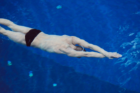 Male swimmer at the swimming pool. Underwater photo. Male swimmer.の写真素材
