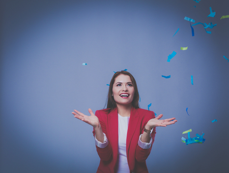 Beautiful happy woman at celebration party with confetti .Birthday or New Year eve celebrating conceptの写真素材