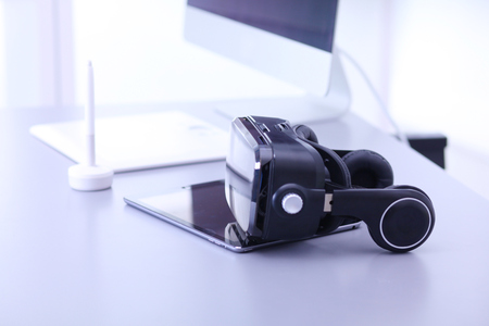 Virtual reality goggles on desk with laptop. business. 3d technologyの写真素材