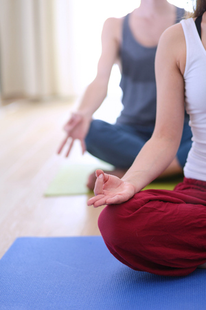 Young healthy couple in yoga position on white background.の写真素材