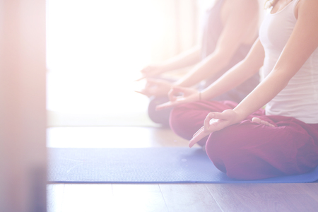 Young healthy couple in yoga position on white background.の写真素材