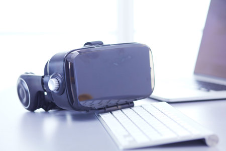 Virtual reality goggles on desk with laptop. business. 3d technology.の写真素材