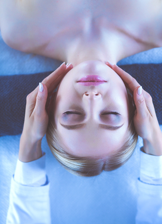 Young woman lying on a massage table,relaxing with eyes closed. Woman. Spa salonの写真素材