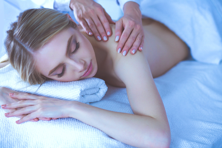 Young woman lying on a massage table,relaxing with eyes closed. Woman. Spa salonの写真素材