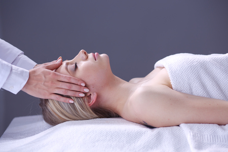 Young woman lying on a massage table,relaxing with eyes closed. Woman.の写真素材