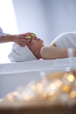 Young woman lying on a massage table,relaxing with eyes closed. Woman.の写真素材