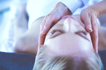 Young woman lying on a massage table,relaxing with eyes closed. Woman. Spa salonの写真素材