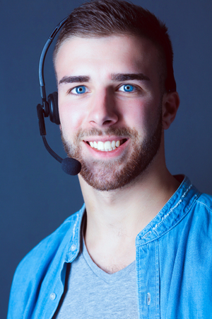 Portrait of young male with microphone. Call-center assistant. Help desk worker.の写真素材