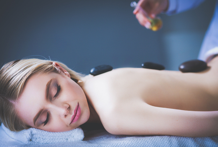 Young woman lying on a massage table,relaxing with eyes closed. Woman. Spa salonの写真素材