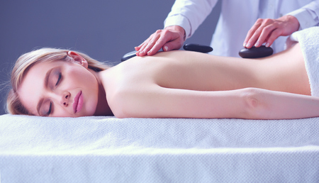 Young woman lying on a massage table,relaxing with eyes closed. Woman. Spa salonの写真素材